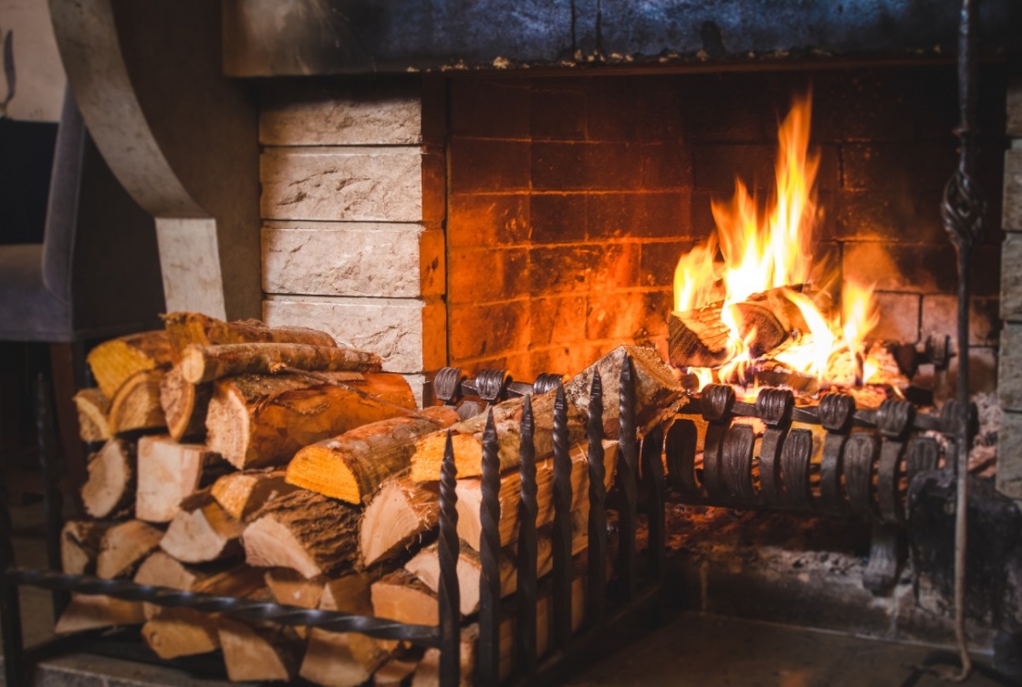 Firewood next to a fireplace.